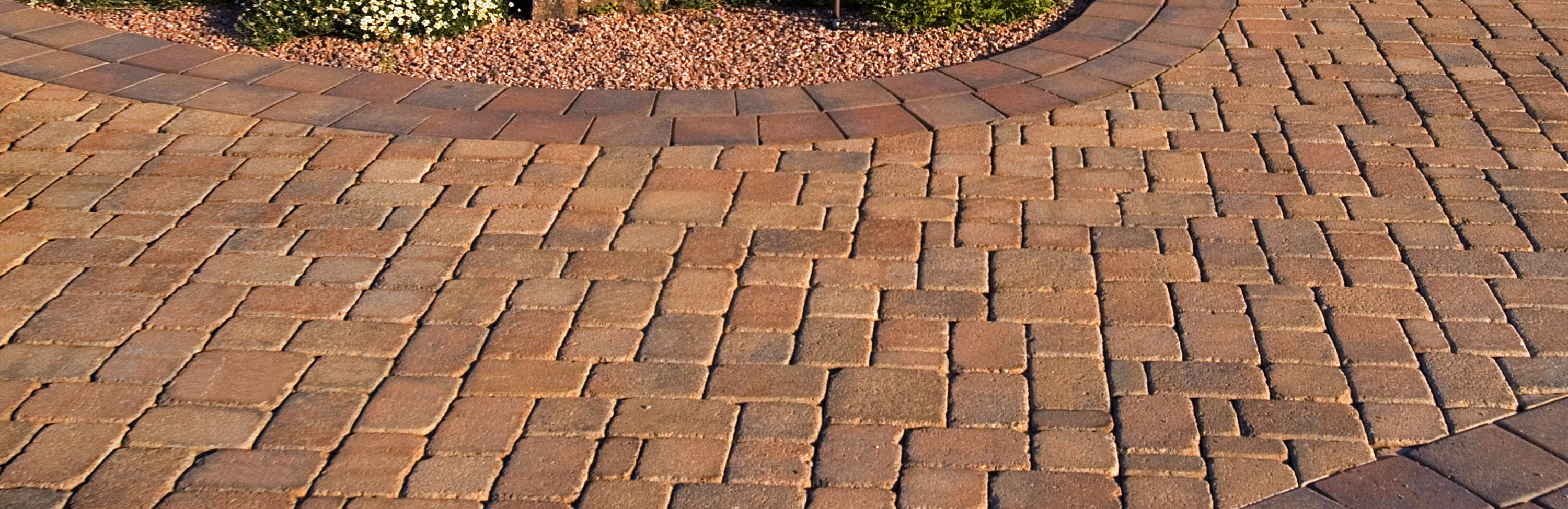 Photograph of Phoenix Paver's Tumbled Pavers in parking area around a 3 bowled water fountain.