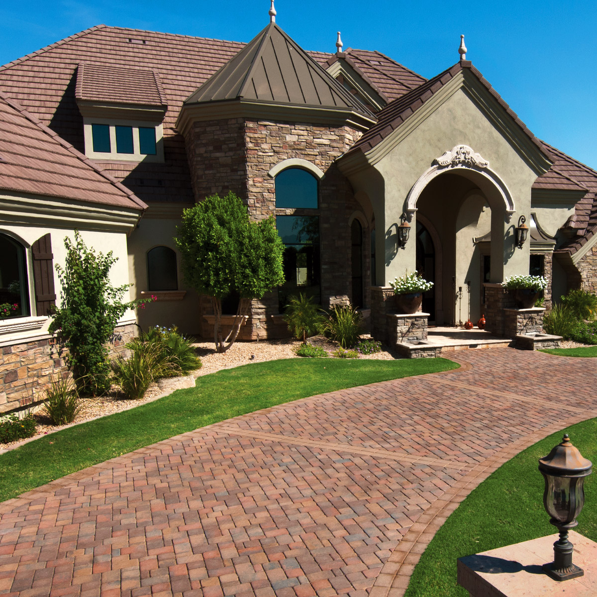  Circular Drive in front of Swiss Revival home. Standard Pavers in Tierra Norte blend and a flat brown border color