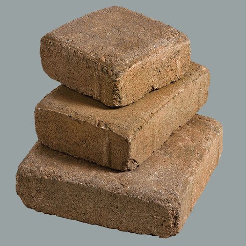  A studio photograph of a stack of three standard pavers that have been tumble processed.