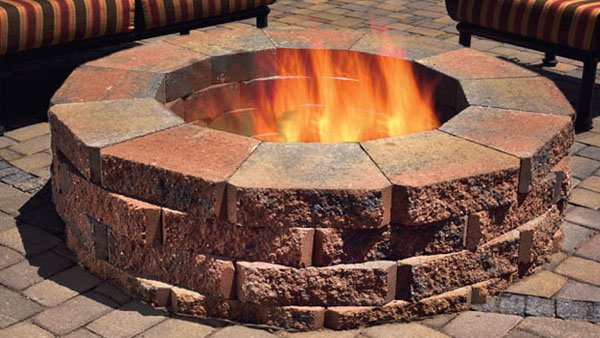 round firepit in color Tierra Norte, flames visable
